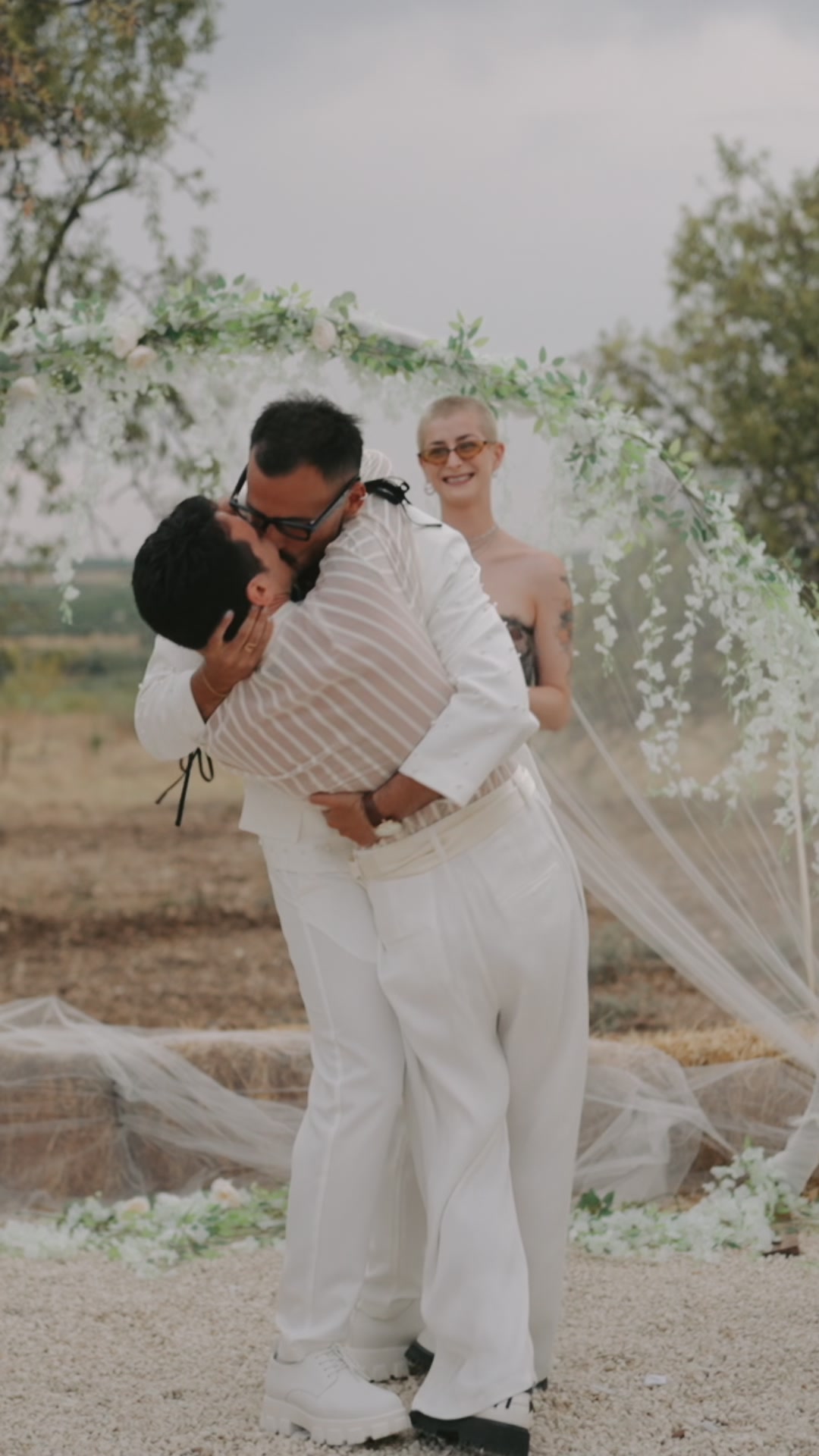 Couple embracing during outdoor wedding ceremony in Sicilian countryside