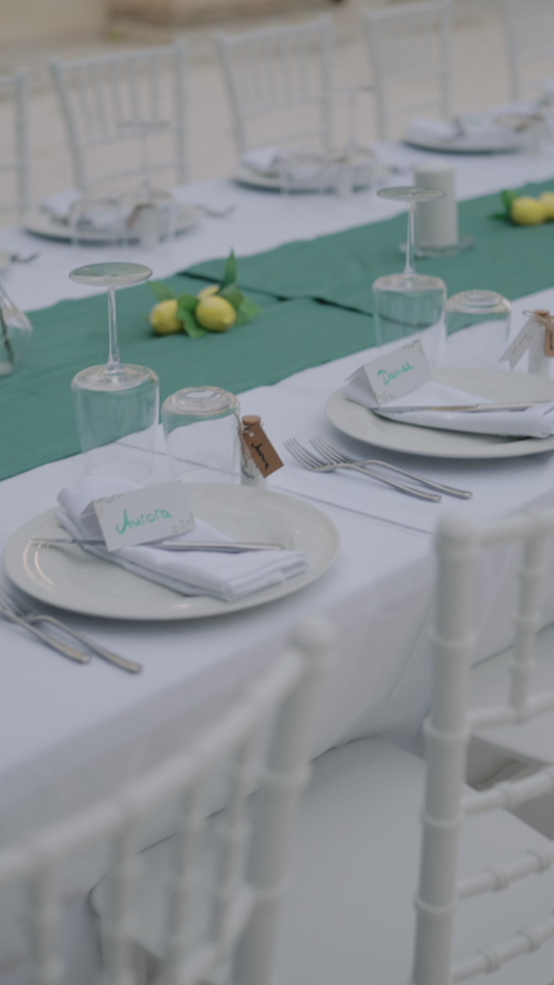 Elegant Mediterranean wedding table setting with lemons and greenery