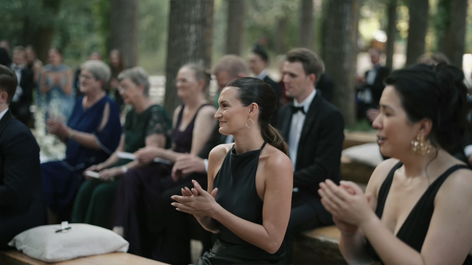 Wedding guests applauding during the forest ceremony in Sicily