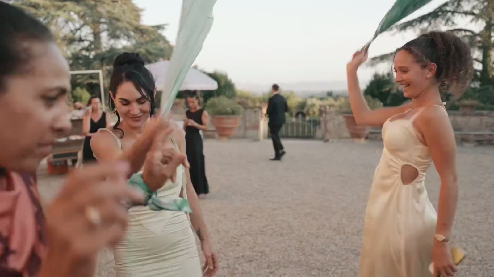 Guests waving green napkins in the air during the wedding celebration