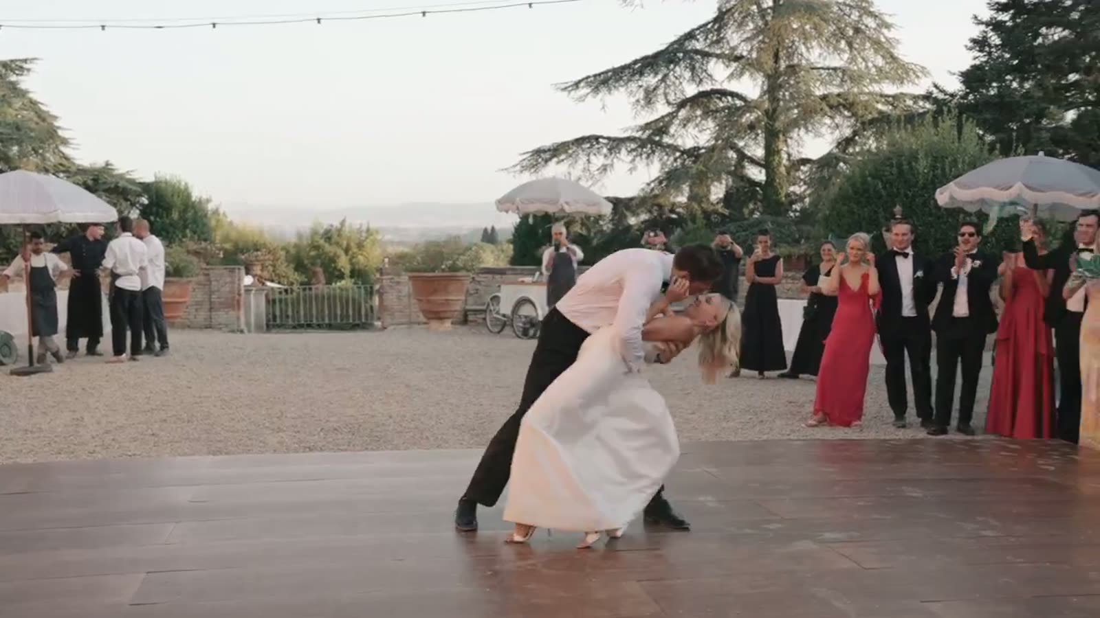 The couple's first dance in the villa courtyard as guests look on